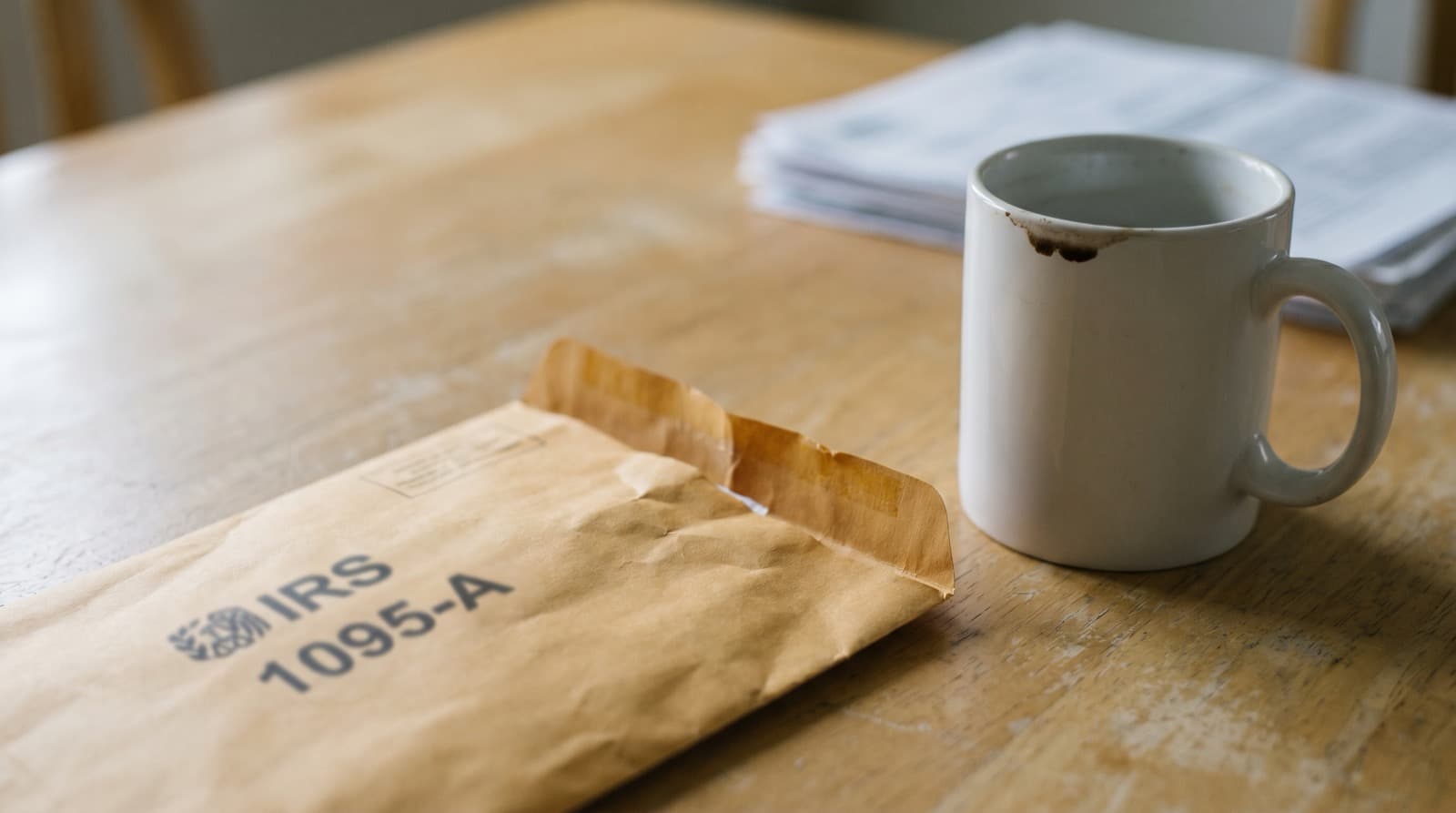 Tax documents and health insurance forms on a desk