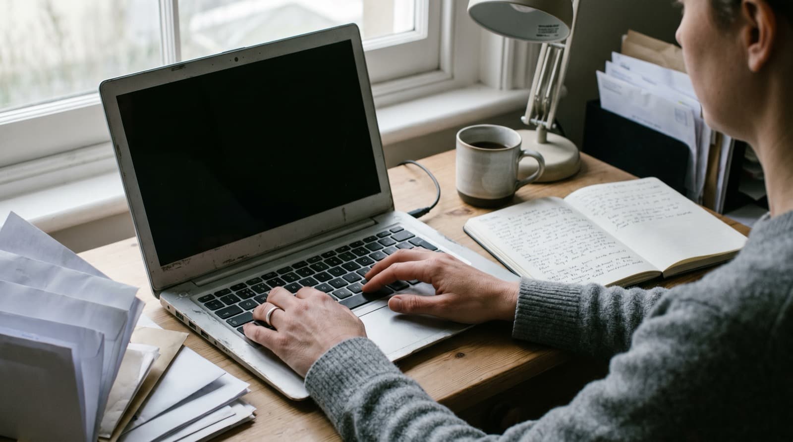 Freelancer working at a coffee shop with a health shield icon above